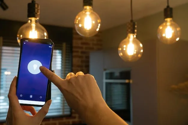 A close-up of a hand holding a smartphone, adjusting the warm glow of smart light bulbs installed in a modern pendant lamp.