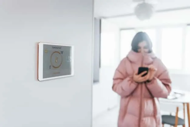 A discreet wall-mounted sensor in a modern living room, subtly integrated into the decor, with an elderly person comfortably reading nearby, symbolizing unobtrusive fall detection technology.