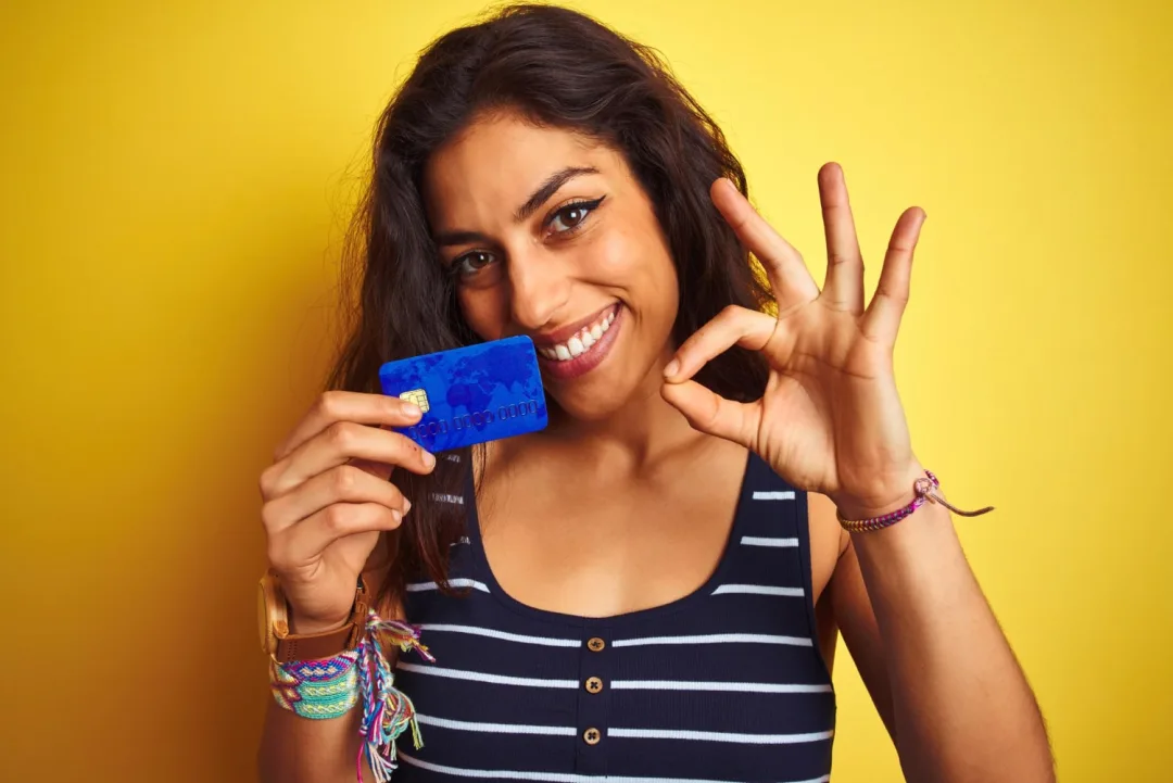 Woman holding her Capital One Platinum Card.