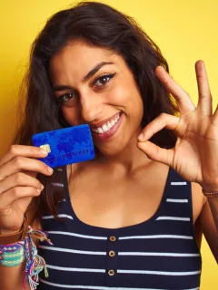 Woman holding her Capital One Platinum Card.