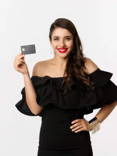 Woman holding her Discover it Secured Card.