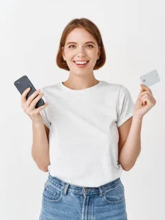 Woman holding her Mission Lane Visa card.