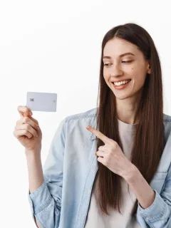 Woman holding her Mission Lane Visa.