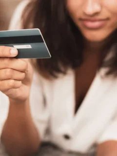 Woman using her QuicksilverOne Capital One Card.