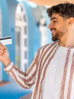 A happy guy learning the Benefits of Using a Credit Card.