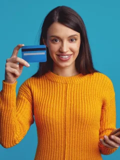 Woman holding her Capital One Platinum Secured Card.