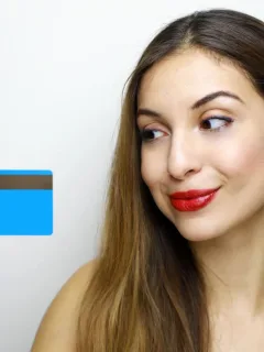 Woman holding her Self Visa Secured card.