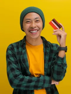 A boy holding his Discover it Student Cash Back.