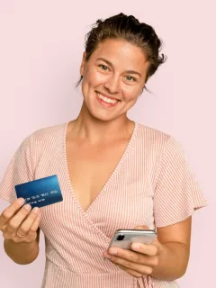 A happy woman holding her United Explorer card.