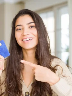 Woman holding her Self Visa Secured Card.