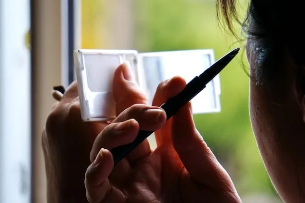 A person discreetly using blotting paper on their T-zone in a brightly lit environment, showing minimal makeup disturbance.