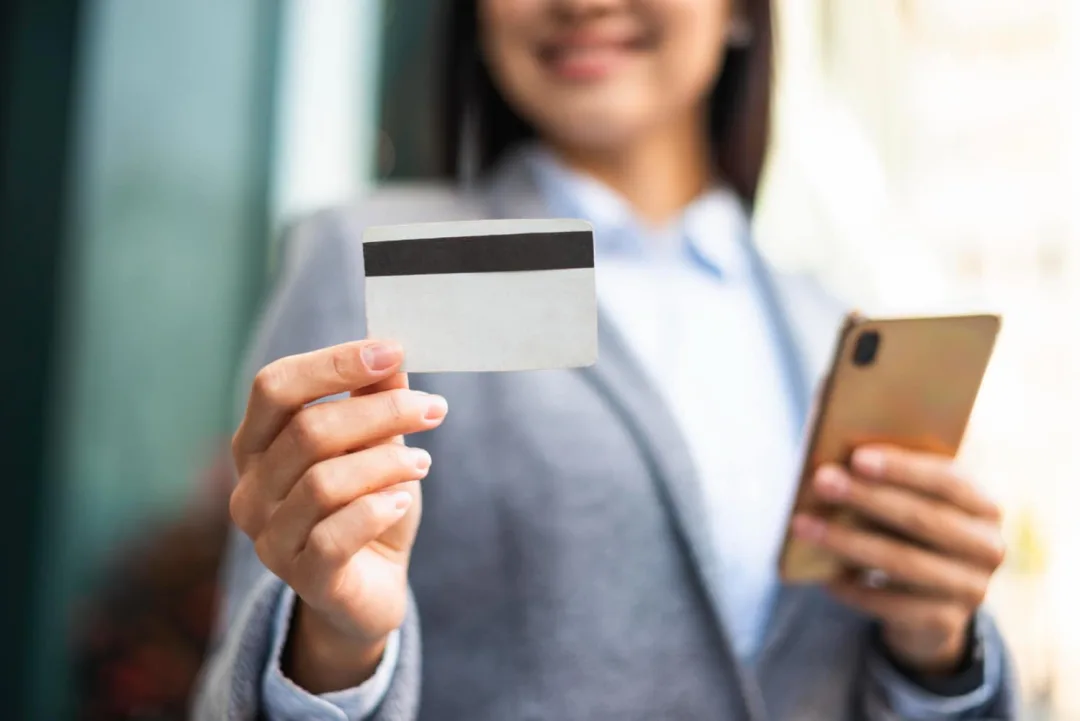 Woman holding her Citi Premier card.