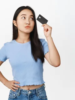 A girl holding her Amazon Prime Visa Card.