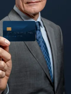 A man holding his INK Business Preferred Card.