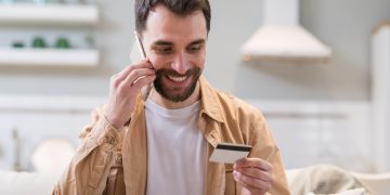 A happy man learning more about Secured and Unsecured Credit Cards and how to choose one.