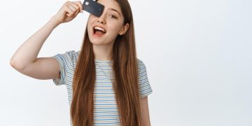 Woman holding her Citi Diamond Preferred card.