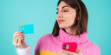 Woman holding a Discover it Cash Back Card.