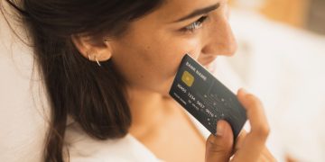 Woman holding the Discover it Secured Credit Card.