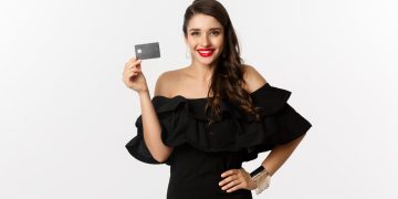 Woman holding her Discover it Secured Card.