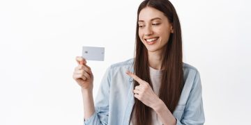 Woman holding her Mission Lane Visa.