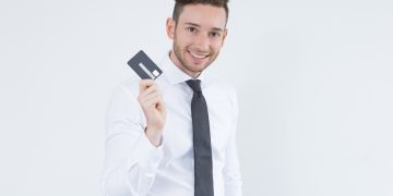 A man holding a Wells Fargo Active Cash Card.