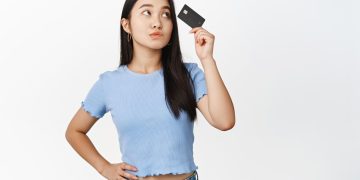 A girl holding her Amazon Prime Visa Card.