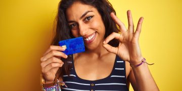 Woman holding her Capital One Platinum Card.