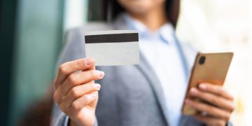 Woman holding her Citi Premier card.