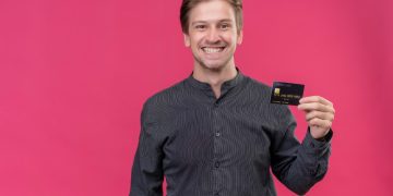 a man holding a GM Business Card.