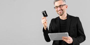 A man holding his GM Business Card.