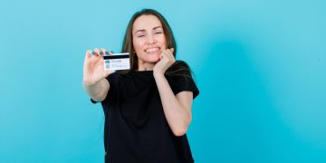 Woman holding her Simmons Visa Card