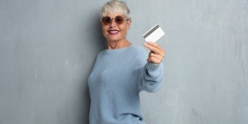 Woman holding her Simmons Visa.