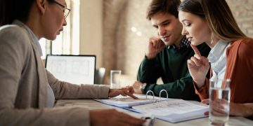 A couple learning about Pros and Cons of Personal Loans.