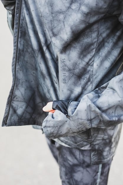 A close-up of a bleached tie-dye t-shirt gently air-drying on a clothesline outdoors, showcasing the crisp white and dark contrasting patterns clearly.
