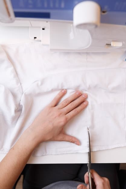 A close-up of a sewing machine needle meticulously stitching straight lines across a fabric and batting sandwich, demonstrating the quilting process.
