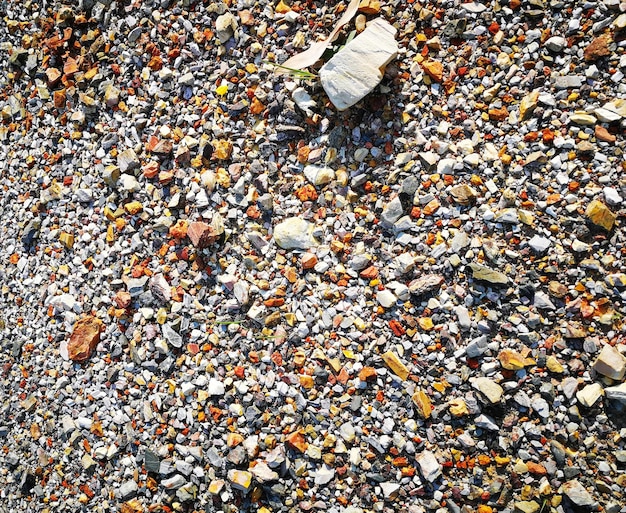 A detailed image showing various recycled aggregates, such as crushed concrete, reclaimed asphalt pavement (RAP), and recycled glass, neatly separated in bins on a construction material yard, ready for reuse.