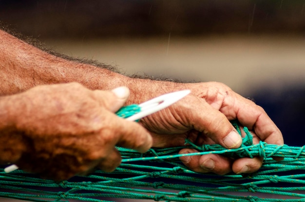 A close-up shot of a construction site worker meticulously inspecting a silt fence for damage or undercutting, emphasizing detailed SWPPP implementation and commitment to environmental compliance.
