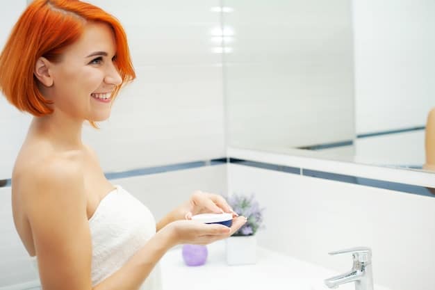 A person applying a gentle cleanser to their face as part of a daily skincare routine, symbolizing effective prevention of acne and scars. The bathroom setting is bright and clean.