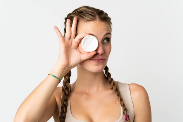 A close-up shot of a hand applying a pea-sized amount of eye cream to the under-eye area, demonstrating proper application technique. The focus is on the delicate skin and the product itself.
