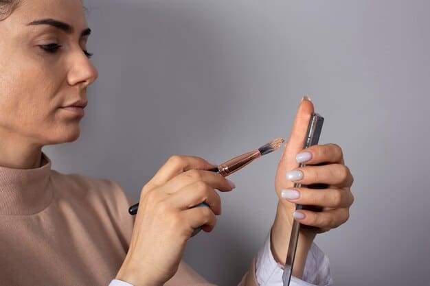 A hand applying a subtle liquid highlighter to the cheekbone with fingertips, demonstrating the natural application technique.