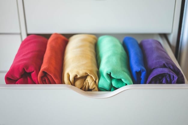 A close-up of a well-organized wardrobe with neatly folded clothes in a curated color palette of neutrals like white, black, gray, and beige, with a few vibrant accessories creating pops of color.