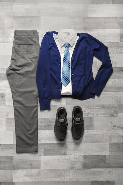 A detailed flat lay of a layered outfit, showcasing a crisp white shirt under a soft gray sweater, topped with a structured navy blazer, illustrating texture and depth.