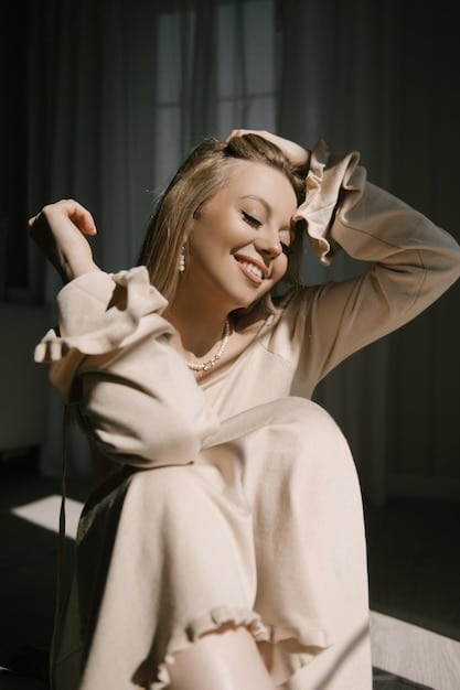A woman wearing a sophisticated monochromatic outfit in various shades of beige and cream, highlighting texture and elegant layering.