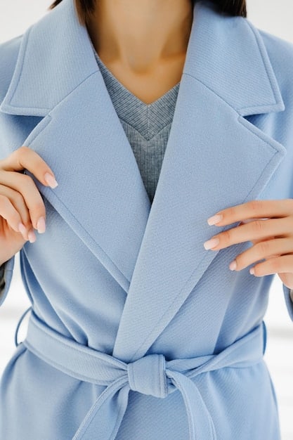 A detailed close-up of a woman's perfectly tailored blazer sleeve, showing the crisp seam and precise length, enhancing a minimalist outfit.