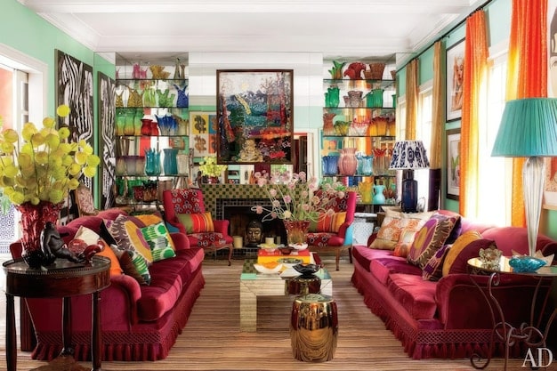 A maximalist living room featuring a mix of vintage furniture, bold patterns, colorful textiles, and an array of unique art pieces and personal mementos, all harmoniously arranged.