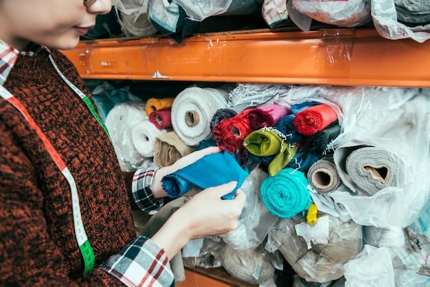 A close-up of hands sorting through different bins of colorful textile scraps, labeled for recycling and upcycling, in a bright, modern workshop