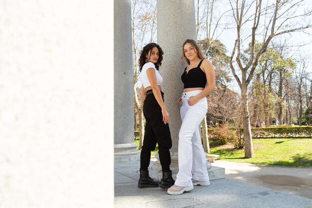 A diverse group of people, illustrating different body types and ages, wearing stylish and functional athleisure wear in various everyday settings – a coffee shop, an outdoor park, a casual office.