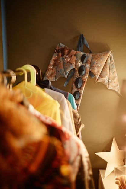 A close-up shot of a hand flipping through a rack of colorful vintage dresses in a dimly lit, atmospheric thrift store, with soft focus on the background.