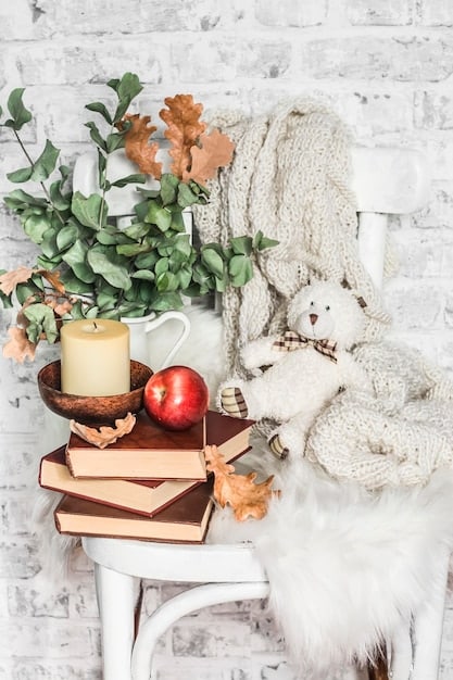 A cozy reading nook with a blend of vintage and modern cottagecore elements, featuring a plush armchair, a rustic wooden side table, and shelves filled with eclectic books and personal trinkets, bathed in soft, natural light within an American home.
