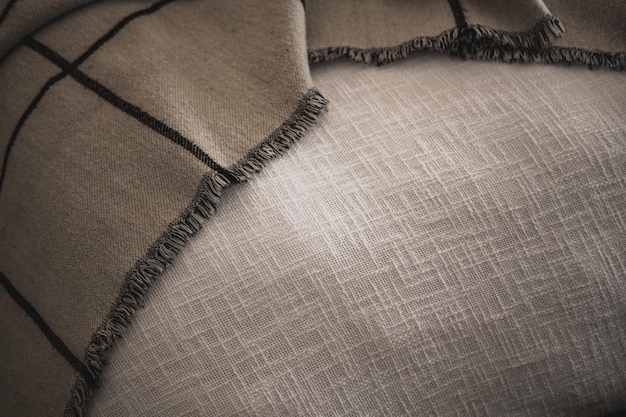 A detailed shot of a luxurious, soft-knit athflow fabric with a subtle texture, perhaps draped over a minimalist chair, showcasing its quality and comfortable feel.
